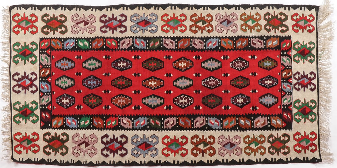A GOOD KILIM WOVEN CARPET: A GOOD KILIM WOVEN CARPET. Overall with geometric designs, with borders and brick red interior panel. 81 x 39 inches (205.7 x 99cm).SHIPPING NOTICE:If you are not using the Live Auctioneers Live Shi