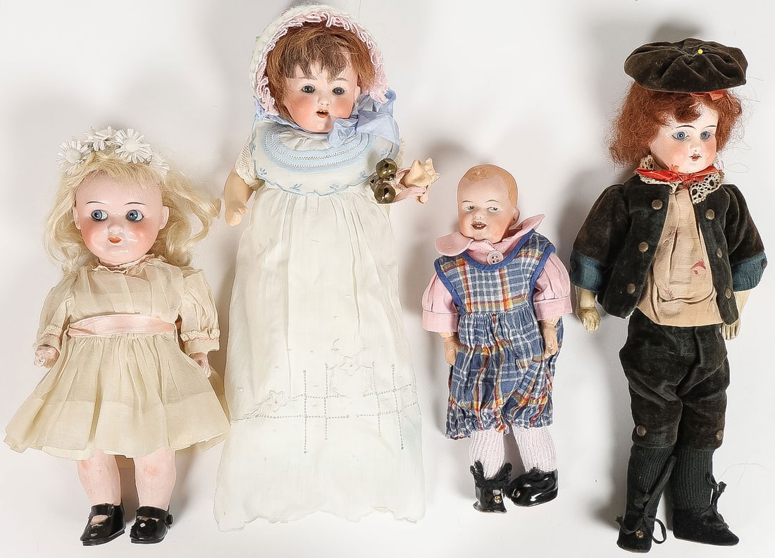 FOUR VINTAGE CHARACTER BISQUE DOLLS: FOUR VINTAGE CHARACTER BISQUE DOLLS. Comprising a blue-eyed Impish googly doll, a German boy with velvet costume, open mouth and glass eyes, a German baby doll with open mouth and glass eyes, and a g