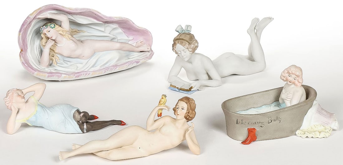 5 GREAT BISQUE BATHING BEAUTIES: 5 GREAT BISQUE BATHING BEAUTIES. Comprising five individual pieces, including a reclining nude Venus set in a clamshell with luster finish; a reclining nude reading a book with raised legs and blue ha
