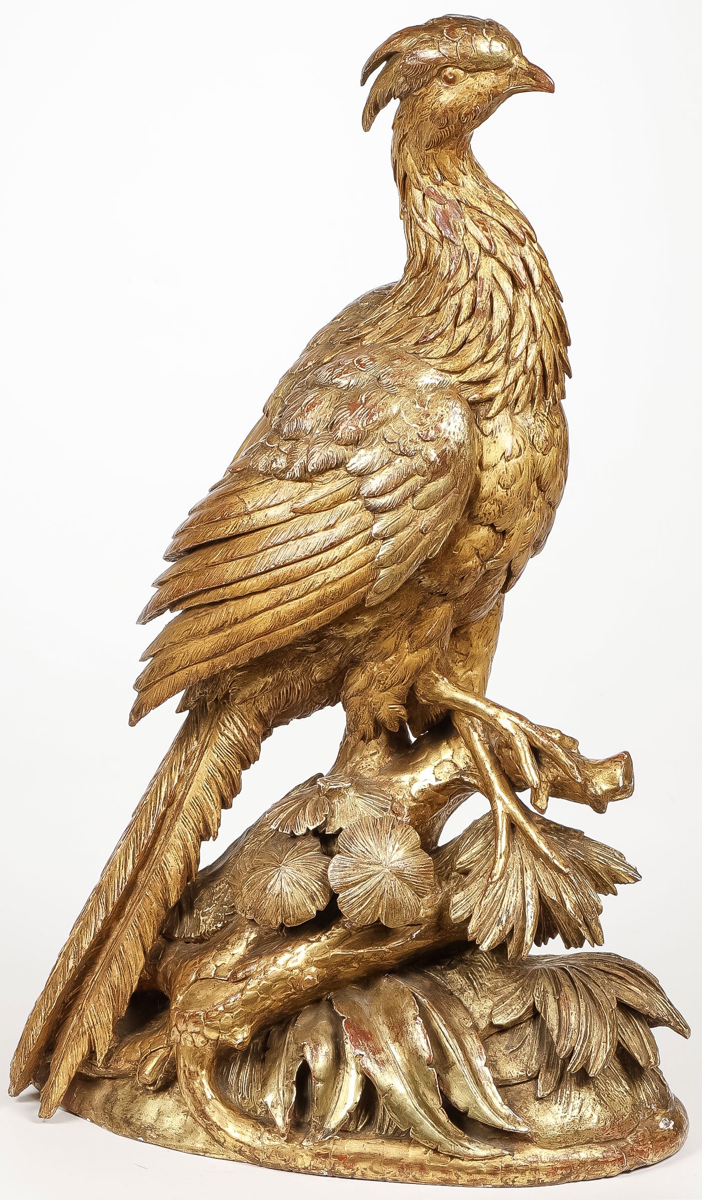 IMPRESSIVE FRENCH CARVED GILTWOOD PHEASANT: IMPRESSIVE FRENCH CARVED GILTWOOD PHEASANT. Comprising a large and impressive carved and giltwood pheasant, carved in full round, resting on a branch atop a rocky outcrop, with excellent anatomy and