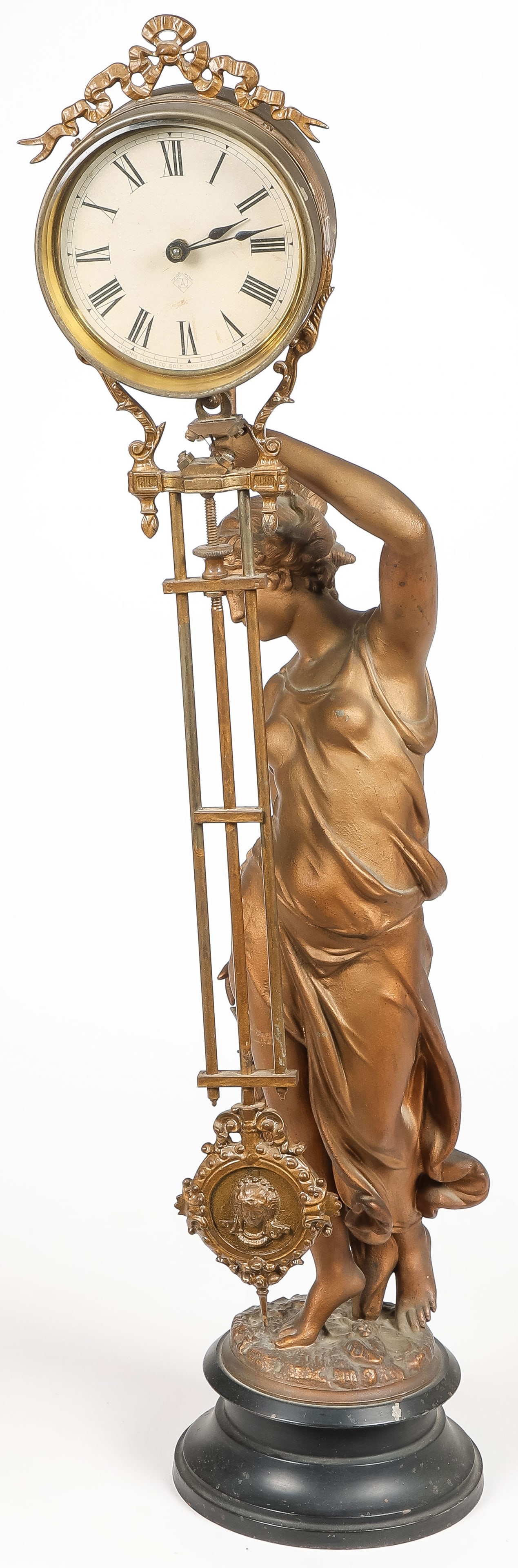 ANSONIA FIGURAL MYSTERY CLOCK: ANSONIA FIGURAL MYSTERY CLOCK. Comprising an Ansonia Clock Company mystery figural clock depicting Diana with an outstretched arm supporting the swinging pendulum clock and holding a clutch of game bi