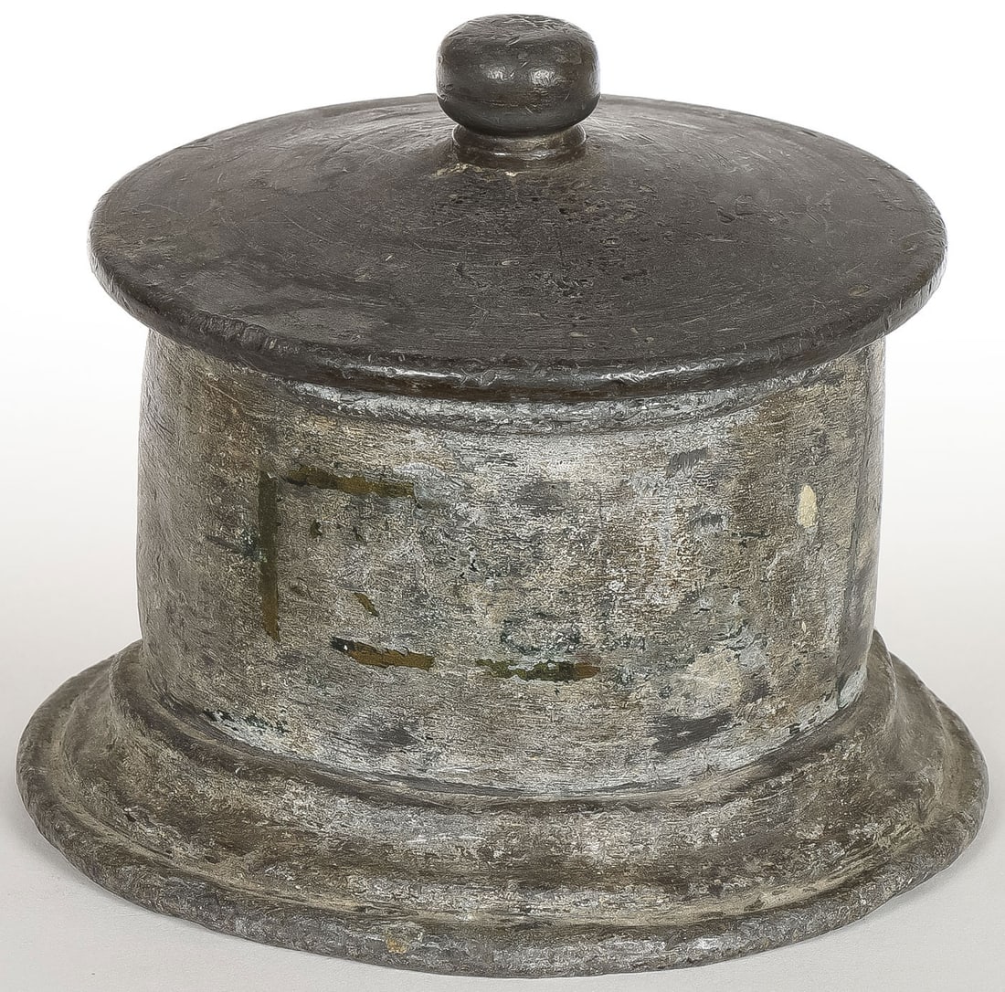 ANCIENT ROMAN LEAD PYXIS: ANCIENT ROMAN LEAD PYXIS. Cylindrical form with flared base and fitted lid with knob finial. Height 4.25 inches.Provenance: Turner Auctions, San Francisco, December 2019, and where acquired by the c