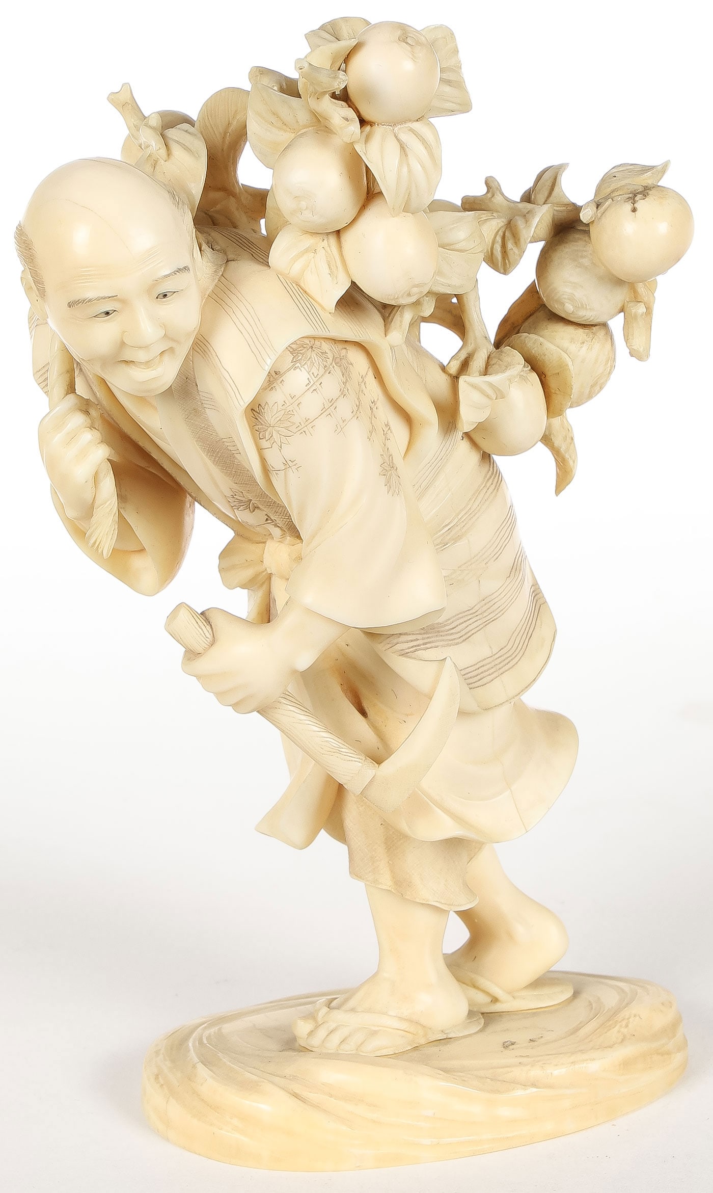 FINE JAPANESE CARVED OKIMONO, MEIJI: FINE JAPANESE CARVED OKIMONO, MEIJI. Comprising a finely carved figure of a fruit seller, carved in full round, of good anatomy and proportion, open mouth with teeth and tongue and etched detailing, w