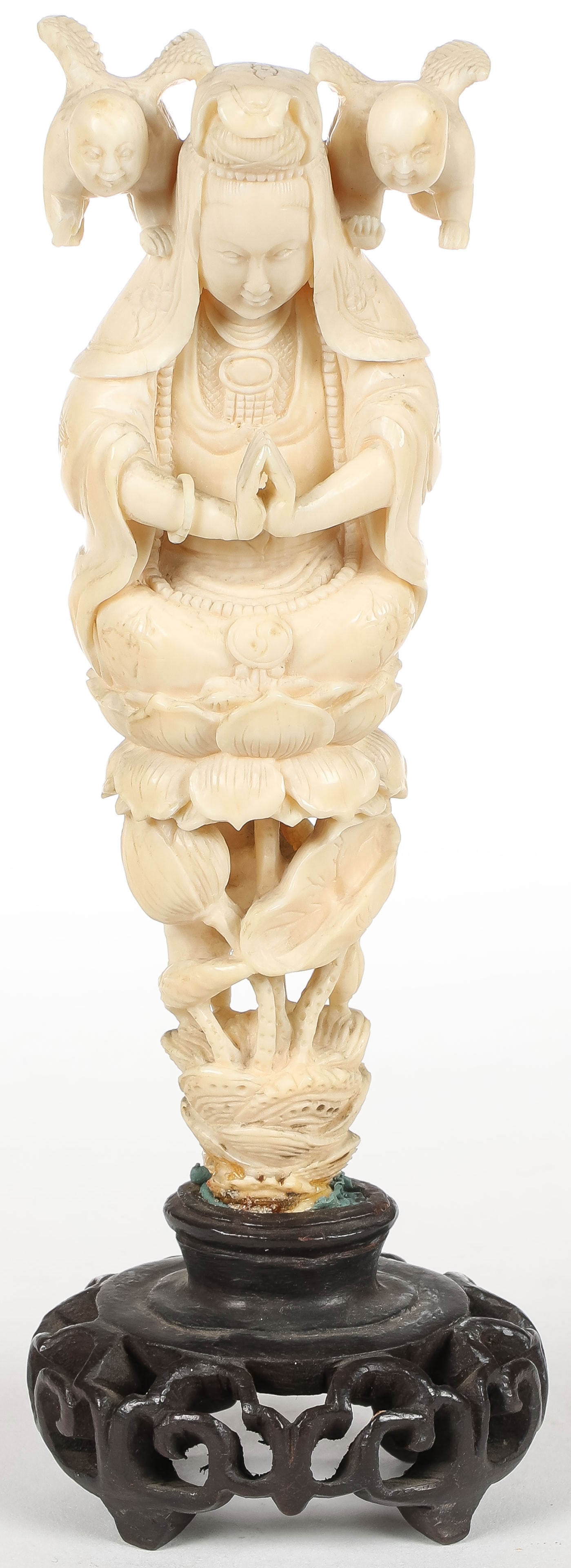 INTERESTING CARVED FIGURE OF KANNON, MEIJI: INTERESTING CARVED FIGURE OF KANNON, MEIJI. Finely and interestingly carved in full round, resting on a double lotus base and with two small attendants representing mercy and resting on a pierced carv