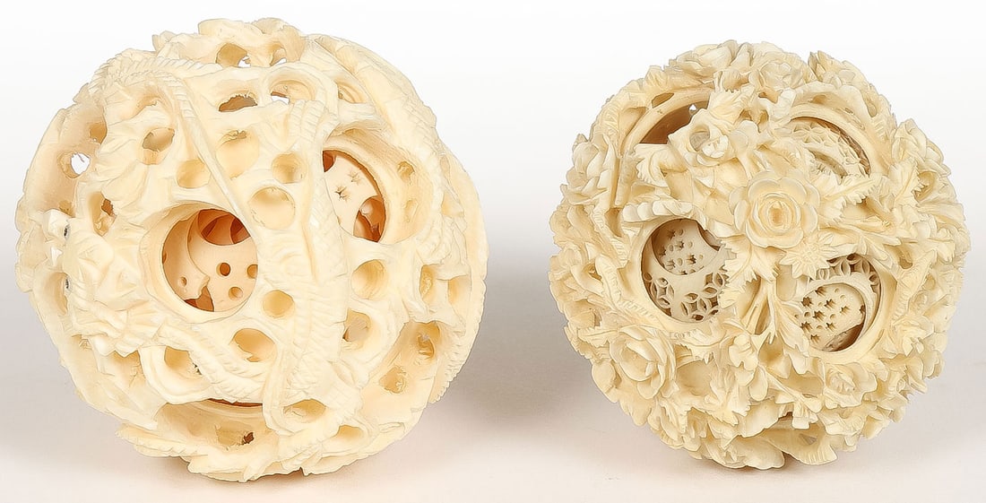 A PAIR OF CHINESE CARVED MYSTERY BALLS: A PAIR OF CHINESE CARVED MYSTERY BALLS. One with dragon motif and the other with floral motif. Greatest diameter 2.5 inches (6.5 cm). Both contained in a velvet-lined, cloth-covered box. NO INTERNATI