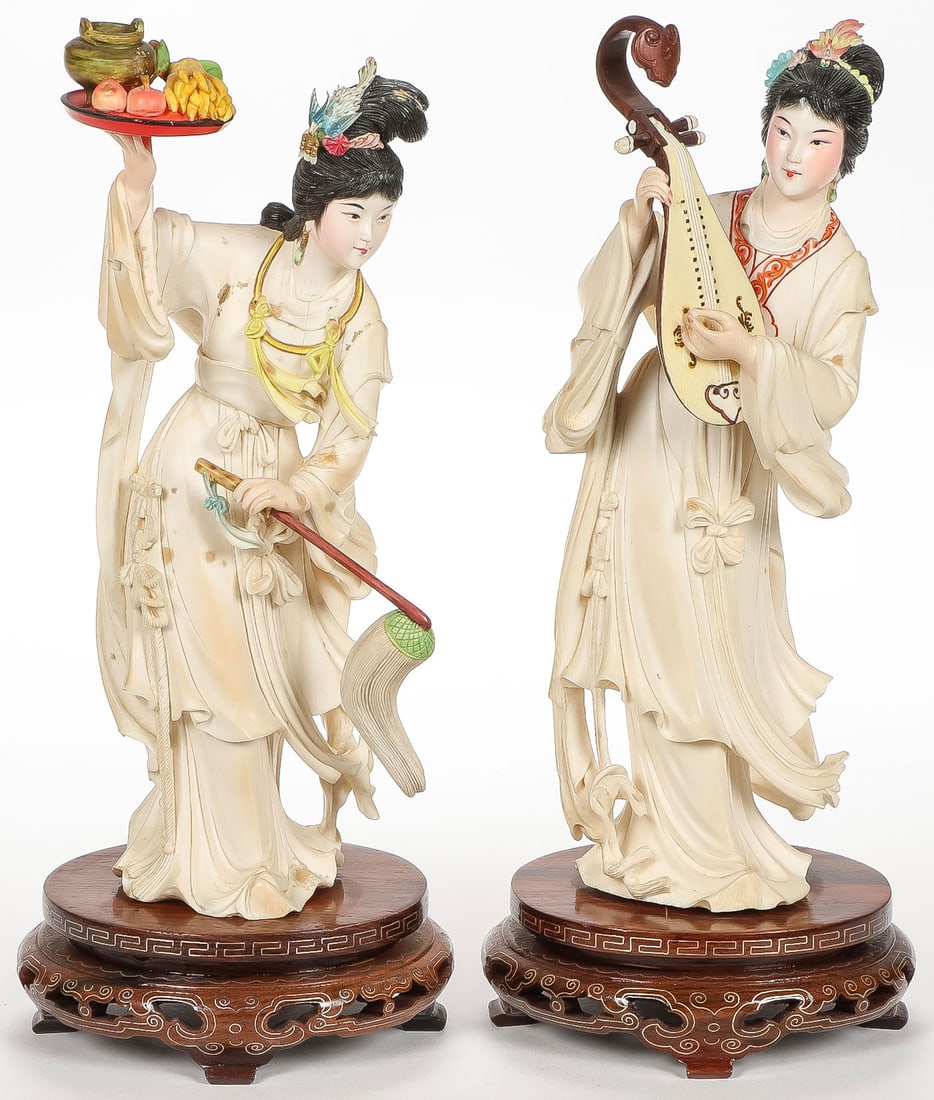 PAIR OF JAPANESE CARVED GEISHA: PAIR OF JAPANESE CARVED GEISHA. Each finely carved in full round, of good anatomy and proportions with flowing robes and polychrome tinted accents. One holding a tray of fruit and fan and the other wi