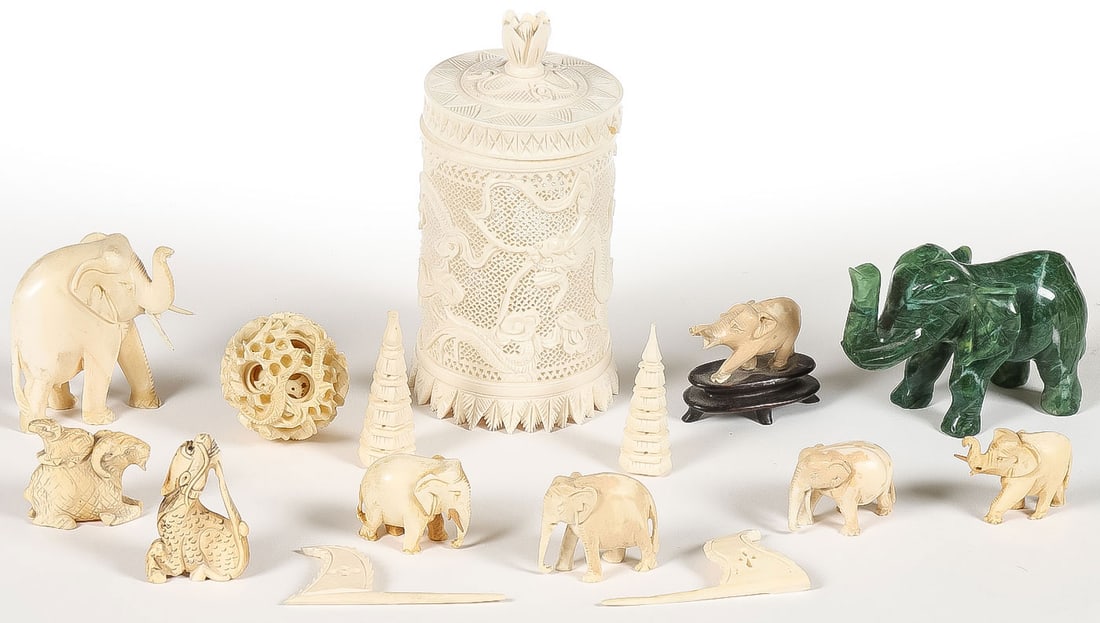 MIXED ASIAN CARVED: MIXED ASIAN CARVED . Comprising a fine pierced carved covered cylinder jar, the sides carved with dragons and with fitted lid set with blossoming finial (some losses to rim of lid), together with a ca