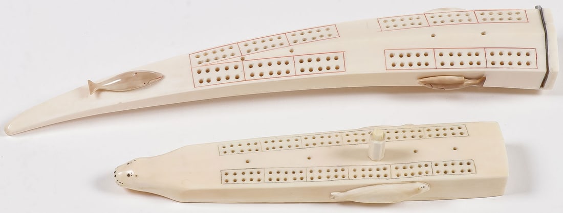 PR OF ESKIMO CARVED WALRUS CRIBBAGE BOARDS: PR OF ESKIMO CARVED WALRUS CRIBBAGE BOARDS. Comprising two finely crafted Eskimo walrus tusk cribbage boards, of the first half 20th century. The largest set with three fish, and with hinged metal doo