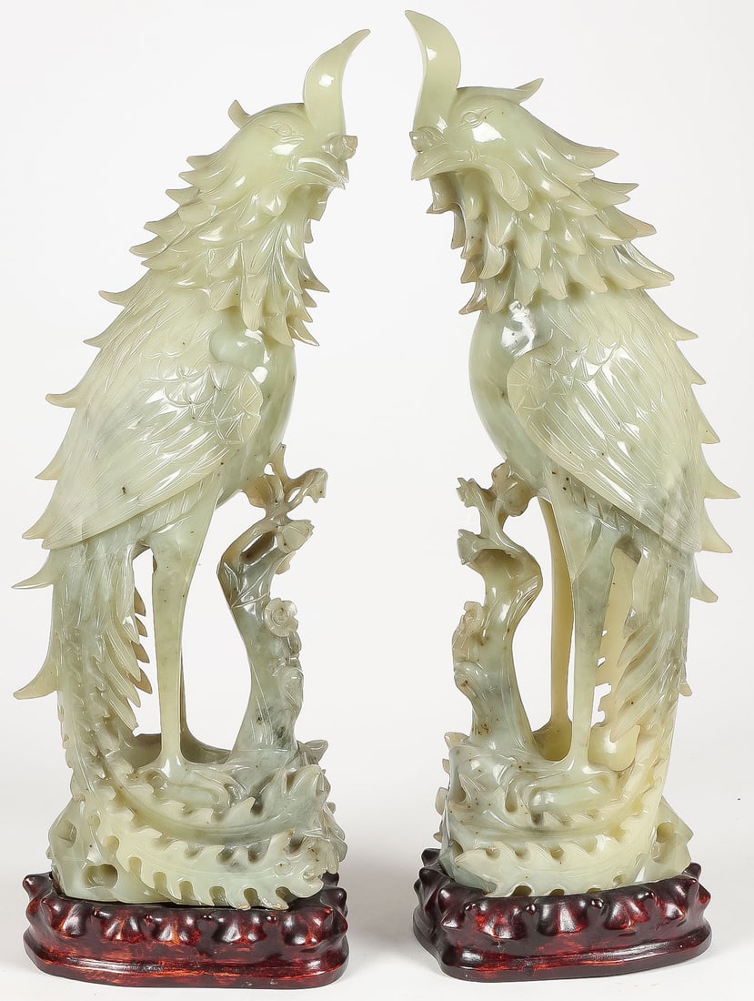 CHINESE CARVED JADE PHOENIX BIRDS, QING: CHINESE CARVED JADE PHOENIX BIRDS, QING. Comprising a pair of large, impressive, and finely carved light green jade phoenix birds on floral branches. Sensitively and finely carved in full round with s
