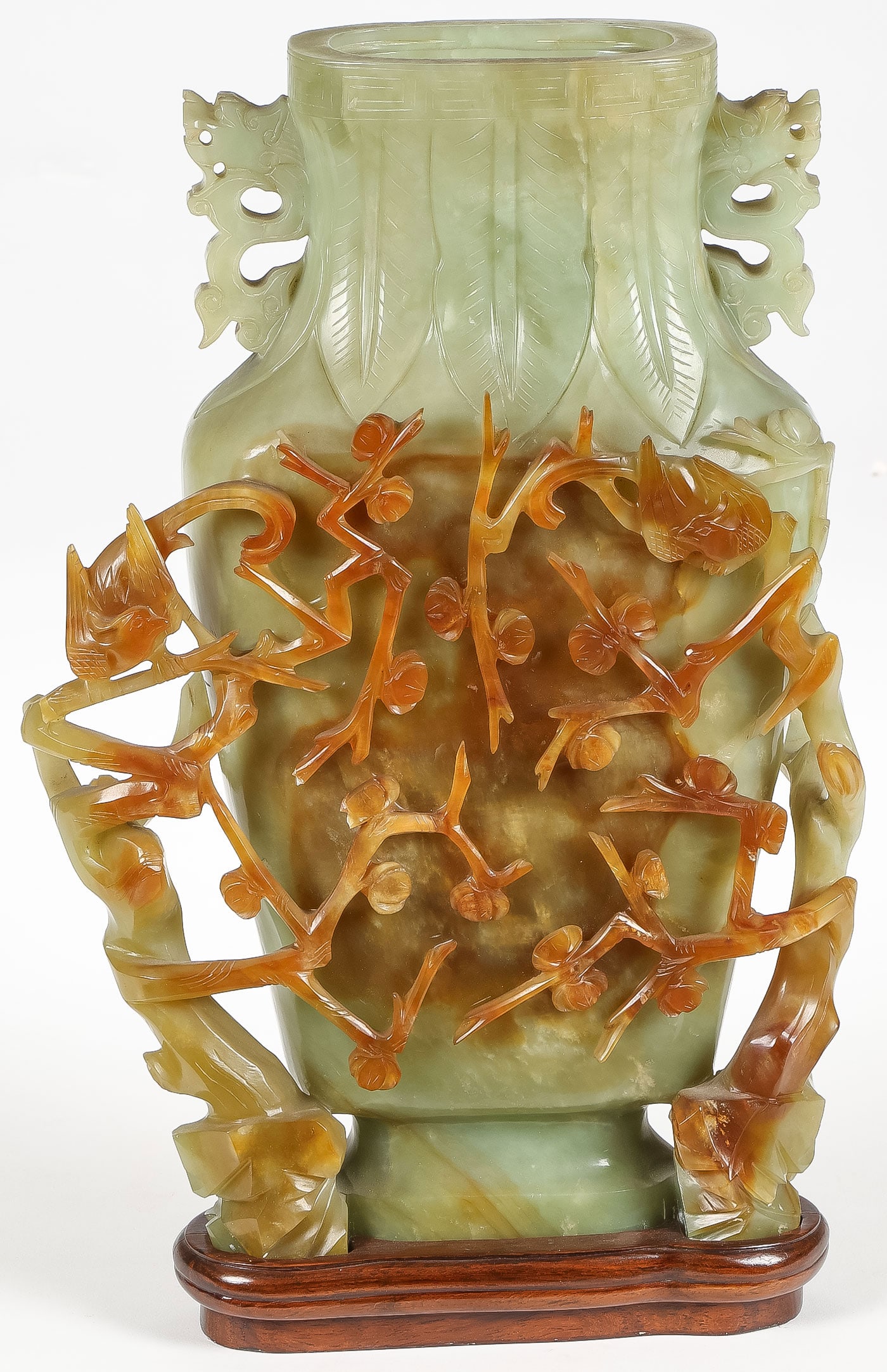 LARGE CHINESE CARVED JADE VASE: LARGE CHINESE CARVED JADE VASE. Comprising a large and impressive carved jade vase with open-work blossoming vines, set with birds, leaf-tipped shoulders, and dragon-head handles. Sans cover. Overall