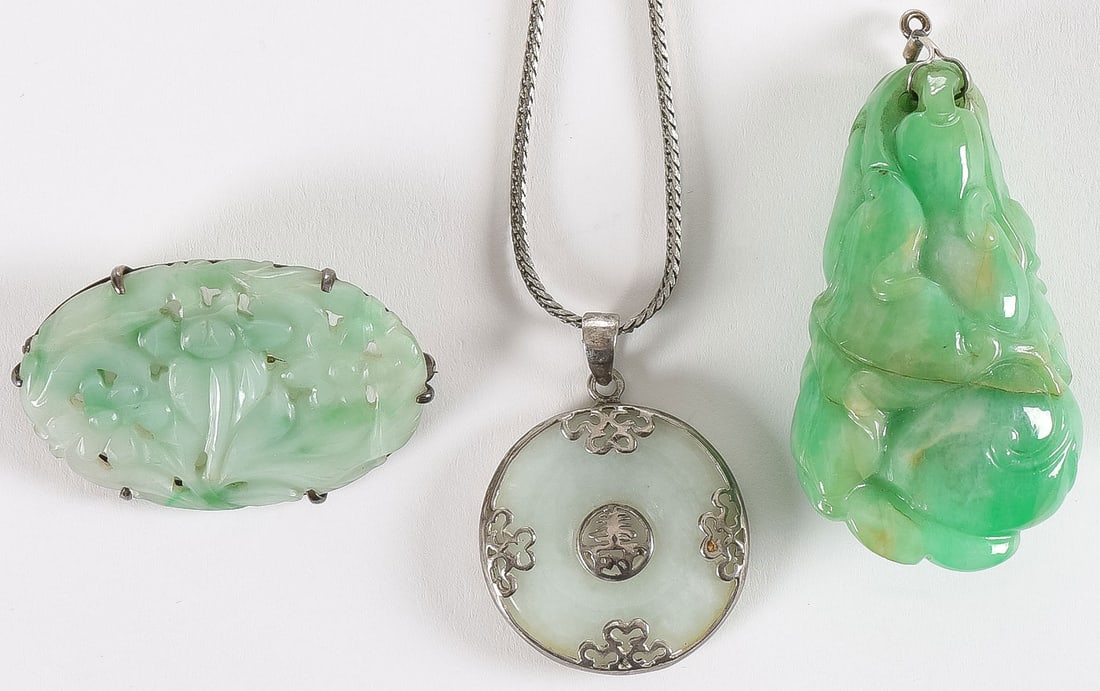 VINTAGE CHINESE CARVED JADE GROUPING: VINTAGE CHINESE CARVED JADE GROUPING. Comprising 3 Chinese carved jade jewelry pieces, including a heavy carved green jade pendant modeled as hanging fruit and on the base a bat, length 2 inches (5cm)