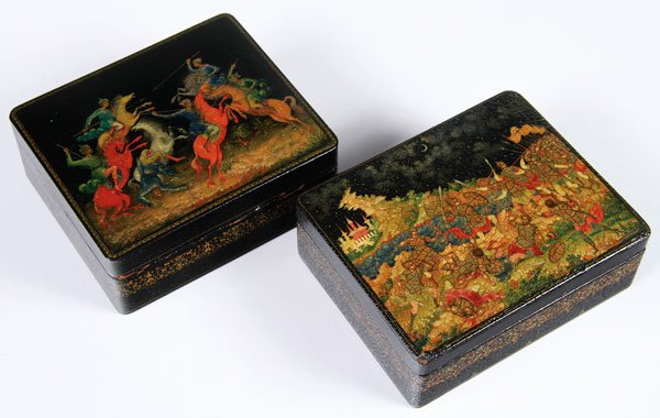 PAIR OF RUSSIAN PALEKH LACQUER BOXES, 1929/1930: A PAIR OF EARLY RUSSIAN PALEKH LACQUER BOXES, 1929 AND 1930. Of rectangular form, the hinged lids painted with a scene of jousting horsemen, and the other with a battle scene. One signed Buranov, Pale