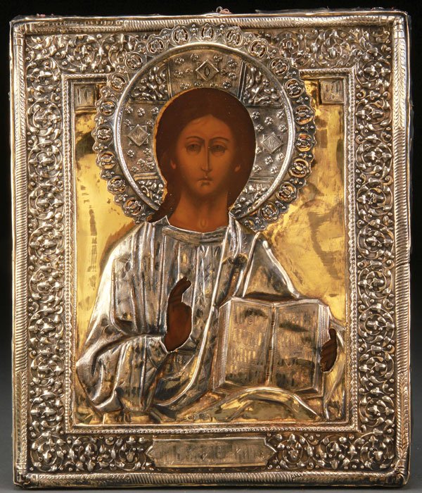 A Russian Icon Of Christ with silver riza, 19th c.: A RUSSIAN ICON OF THE LORD ALMIGHTY, 19TH CENTURY. Fully painted icon depicting Christ delivering a blessing and holding an open book of gospels to Matthew 11:28. Overlaid with a silver-gilt, repouss�