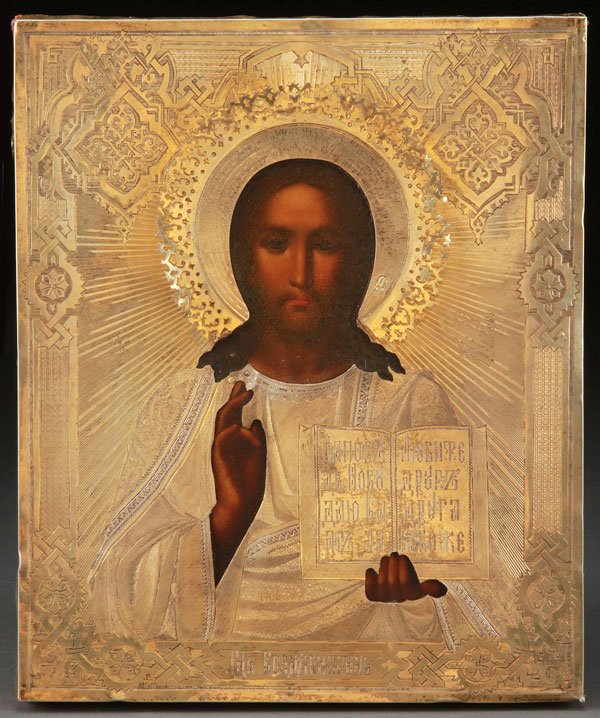 A RUSSIAN ICON OF CHRIST THE LORD ALMIGHTY: A RUSSIAN ICON OF CHRIST THE LORD ALMIGHTY. Naturalistically rendered and overlaid with an ornate silver-gilt machine engraved riza. Hallmarked Moscow, dated 1885, Cyrillic maker's mark N.Z. and 84 si