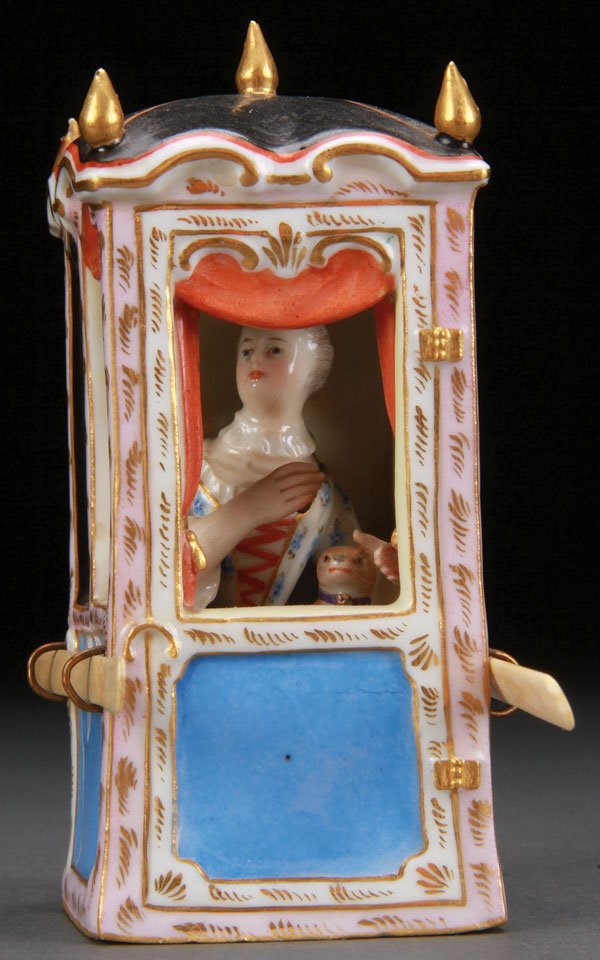 MEISSEN PORCELAIN SEDAN CHAIR, 19TH CENTURY: A MEISSEN PORCELAIN SEDAN CHAIR, 19TH CENTURY. Modeled as an 18th century lady with pug seated in a sedan chair with ivory supports (attendants absent). Crossed pommeled sword marks in blue. Height 4