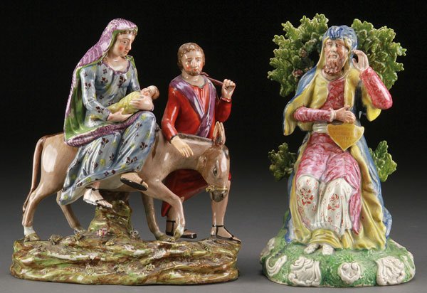 TWO STAFFORDSHIRE PEARLWARE FIGURES, EARLY 19TH C: TWO STAFFORDSHIRE PEARLWARE FIGURES, EARLY 19TH CENTURY. Comprising a “Flight into Egypt” group, England, circa 1830, modeled as male and female travelers with an infant and donkey, mounted atop