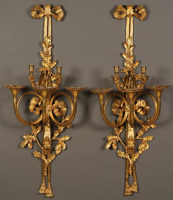PAIR OF FRENCH SECOND EMPIRE GILT BRONZE SCONCES: A PAIR OF LARGE AND IMPRESSIVE FRENCH SECOND EMPIRE GILT BRONZE WALL SCONCES, 19TH/20TH CENTURY. Each with two scrolled candle arms with sculpted camel head terminals and dragonfly wings above three c