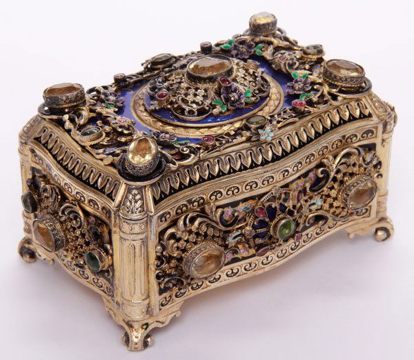 SILVER-GILT AND JEWELED ANIMATED BIRD MUSIC BOX: A VIENNESE STYLE ENAMELED SILVER-GILT AND JEWELED ANIMATED BIRD AND MUSICAL BOX, POSSIBLY 19TH CENTURY. Of rectangular form with serpentine shaped panels overlaid with reticulated and enameled florals