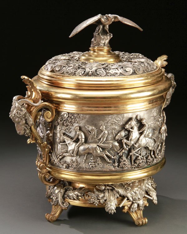 ELKINGTON SILVERED & GILT BRONZE CENTERPIECE: A LARGE AND IMPRESSIVE ELKINGTON SILVERED AND GILT BRONZE STEEPLE CHASE SCENIC TROPHY CUP/CENTERPIECE, CIRCA 1880. Of circular form, finely sculpted in deep relief in the round, with an animated steep