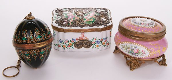 THREE LIMOGES ENAMELED & GILT BRONZE BOXES: THREE FINE LIMOGES ENAMELED AND GILT BRONZE BOXES, 19TH CENTURY. An oval footed box with floral medallions and faux seed pearls on pink enameled ground; an emerald green, jeweled and guilloche enamele