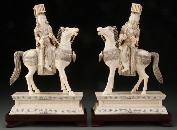 CHINESE CARVED IVORY EMPEROR AND EMPRESS GROUP: A LARGE CHINESE CARVED IVORY EMPEROR AND EMPRESS EQUESTRIAN GROUP. Each modeled as a fully attired Emperor and Empress mounted on horseback, raised on shaped rectangular ivory plinths and further rais