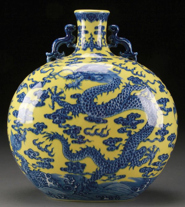CHINESE BLUE AND WHITE WITH YELLOW MOON FLASK: A VERY FINE CHINESE BLUE AND WHITE WITH YELLOW GROUND "DRAGONS" MOON FLASK. Finely decorated with two coiled dragons within stylized cloud, flame forms and bats above a wavy sea. Surmounted with two f