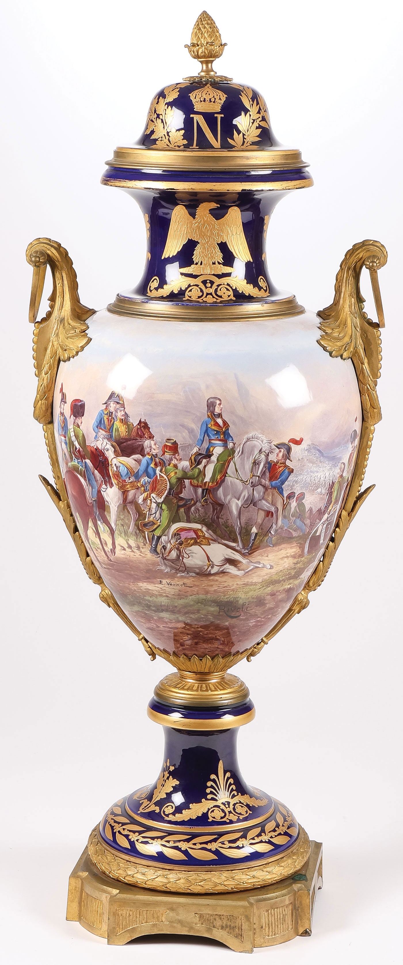 MONUMENTAL SEVRES NAPOLEONIC VASE: MONUMENTAL SEVRES NAPOLEONIC VASE SIGNED E. VERNET. Comprising a large and impressive ormolu-mounted, hand-painted cobalt and gilt-decorated Sevres or Sevres style porcelain Napoleonic lidded vase. Of