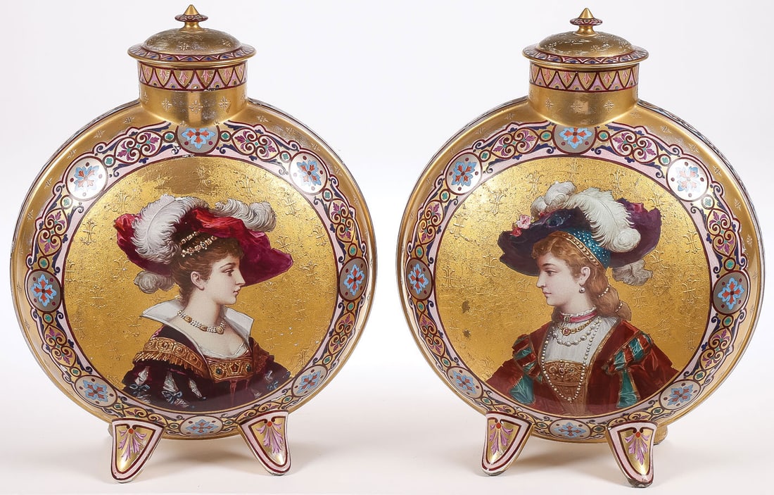 PR EXCEPTIONAL MOON FLASK COVERED URNS: PR EXCEPTIONAL MOON FLASK COVERED URNS. Comprising a pair of matching French (possibly Sevres) hand-painted and gilt decorated porcelain moon flask lidded urns, each resting on four spread legs, the