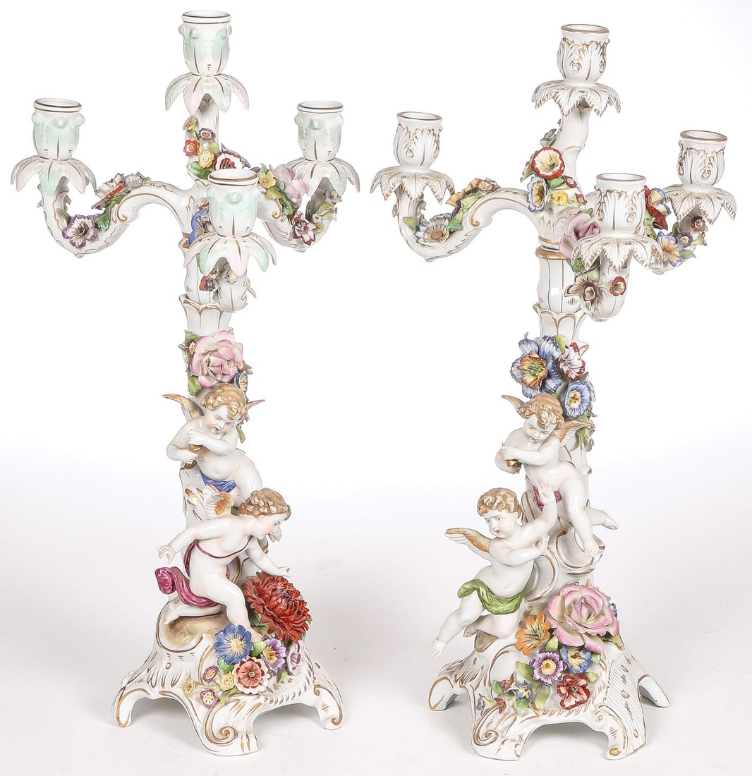 PR PORCELAIN PUTTI CANDELABRA: PR PORCELAIN PUTTI CANDELABRA. Comprising a pair of ornate hand-painted and gilt-decorated porcelain four-light candelabra. On rocaille gilt-decorated bases with applied flowers, the central stem