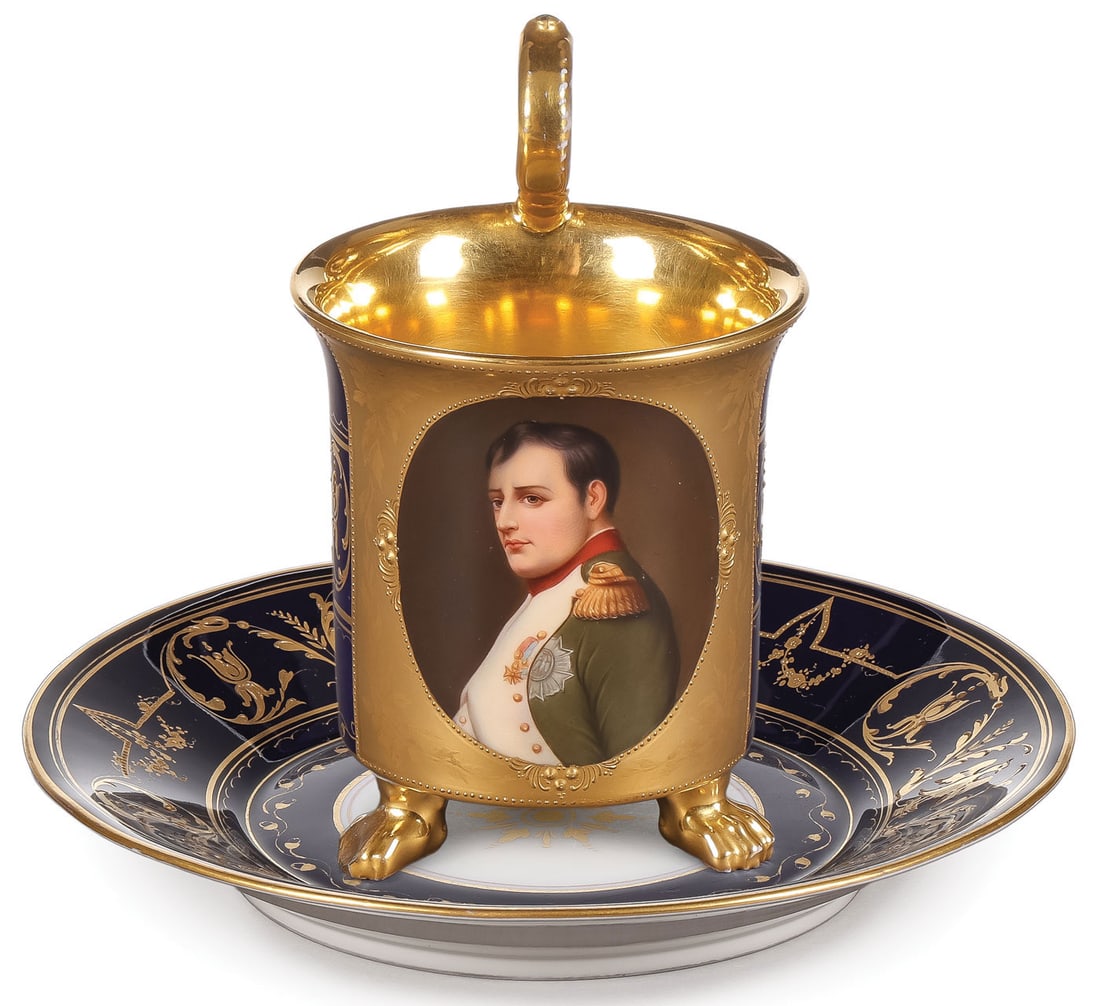 EXCEPTIONAL KPM NAPOLEAN CUP & SAUCER: EXCEPTIONAL KPM NAPOLEAN CUP & SAUCER. Comprising a cobalt and gilt-decorated KPM matching cup and saucer, the front of cup with finely painted bust portrait of Napoleon within a burnished gilt