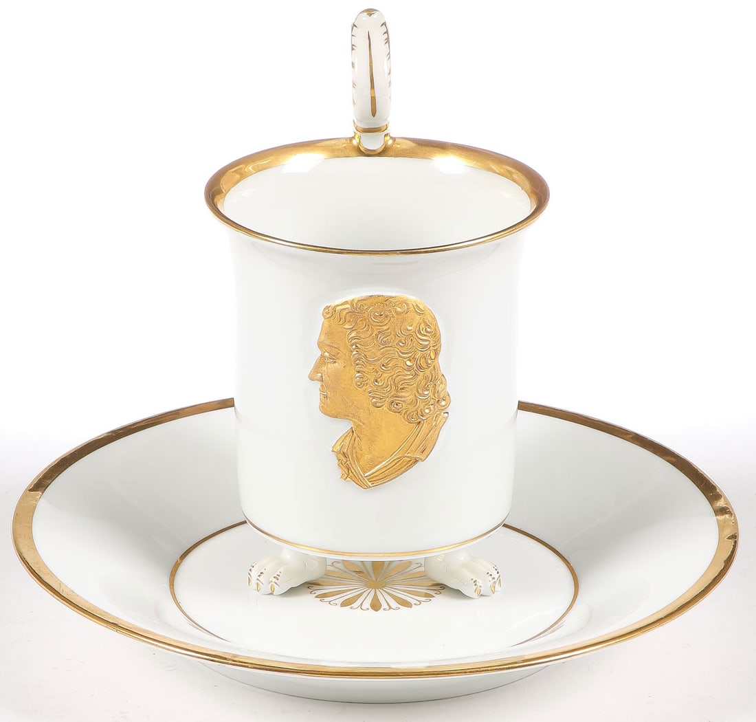 GOOD GILT DECORATED MEISSEN CUP & SAUCER: GOOD GILT DECORATED MEISSEN CUP & SAUCER. Comprising a matching white porcelain and gilt-decorated Meissen cup and saucer, the cup raised on three paw feet and with gilt-decorated scroll handle and
