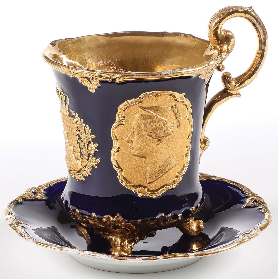 MEISSEN COLBALT & GOLD ROYAL CUP & SAUCER: MEISSEN COLBALT & GOLD ROYAL CUP & SAUCER. Comprising a large and impressive Meissen porcelain cobalt- and gilt-decorated cup and saucer, circa 1854. The cup raised on three gilt scrolled feet, and