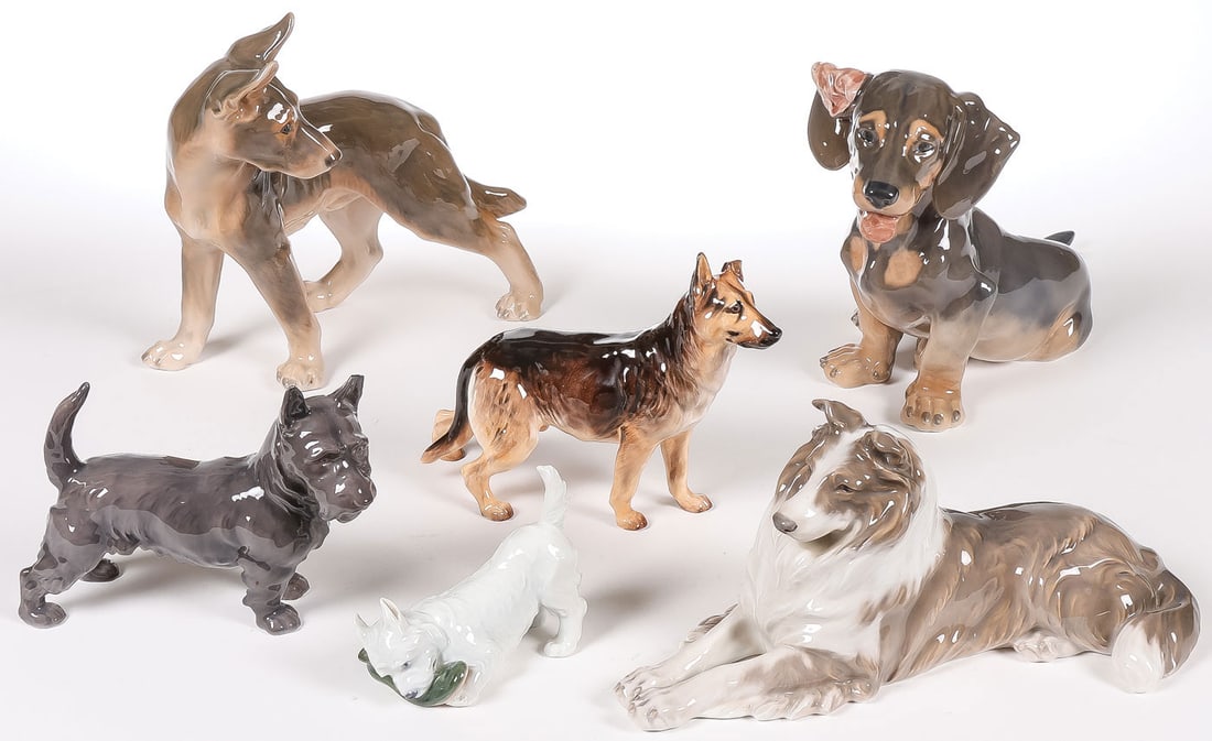 6 PORCELAIN DOG FIGURES: 6 PORCELAIN DOG FIGURES. Comprising three Royal Copenhagen dogs, including a seated collie, model number 162; a dachshund, model number 856; and a terrier chewing a slipper, model number 3476. Togethe