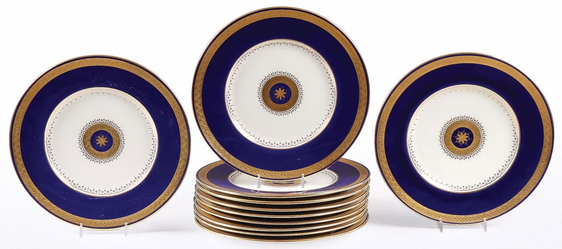MINTON FOR TIFFANY DINNER PLATES: MINTON FOR TIFFANY DINNER PLATES. Comprising a set of 11 cobalt blue and gilt decorated dinner plates, the center medallion with etched gilt flower head, encircled with etched intertwined pattern, and