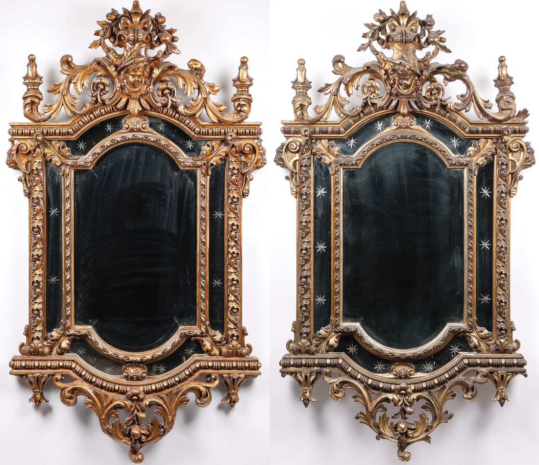 PR ELABORATE CARVED & GILT WOOD MIRRORS, 19TH C: PR ELABORATE CARVED & GILT WOOD MIRRORS, 19TH C. Comprising a matching pair of ornately carved and gilt wood frames, the crest featuring a cherub face among intricately carved scrolling acanthus leave