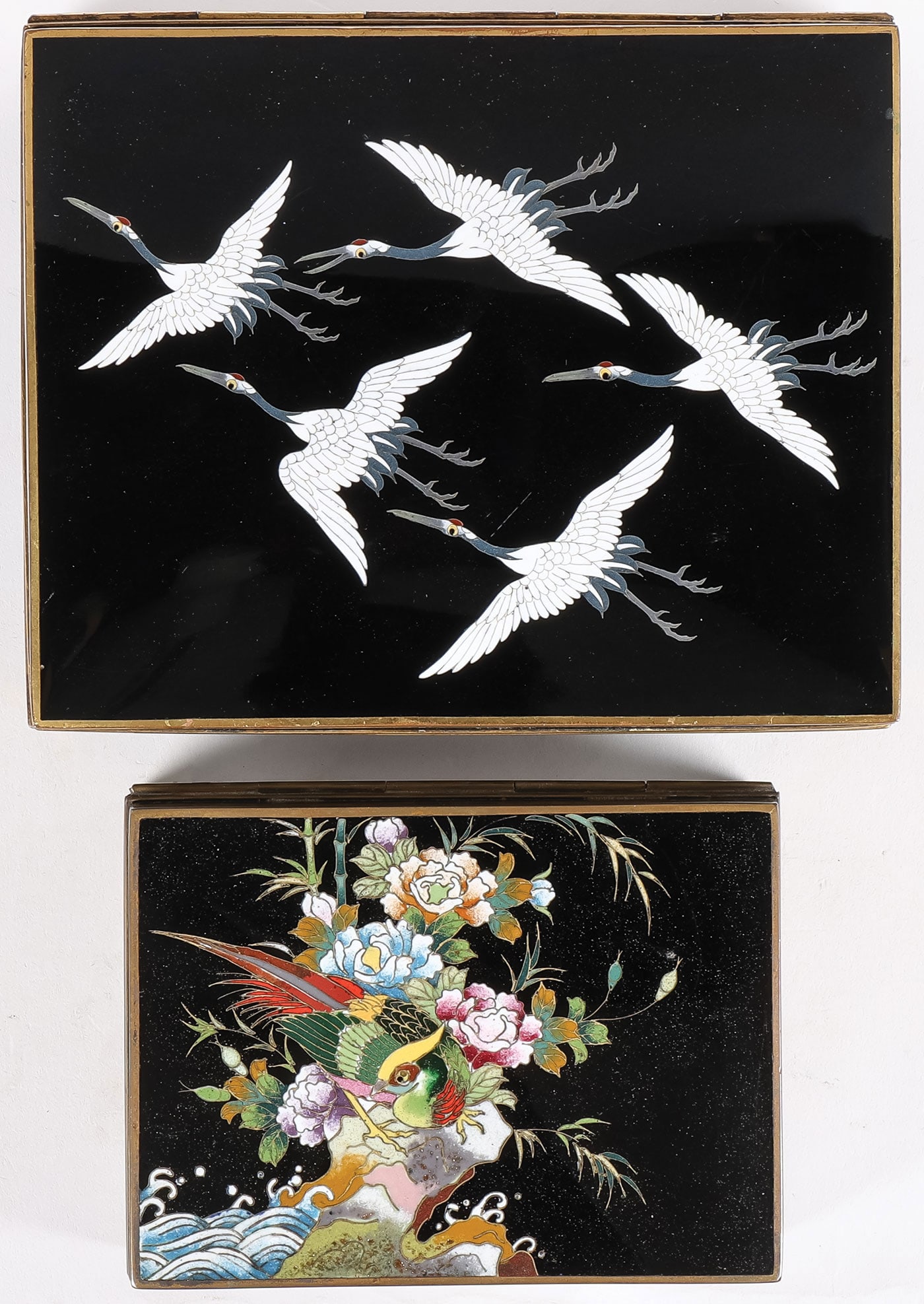 PR JAPANESE CLOISONNE BOXES, INABA, MEIJI: PR JAPANESE CLOISONNE BOXES, INABA, MEIJI. Comprising a pair of finely enameled boxes, Meiji. Including a large divided cigarette box, the hinged lid with flying cranes on a black ground, and banded w