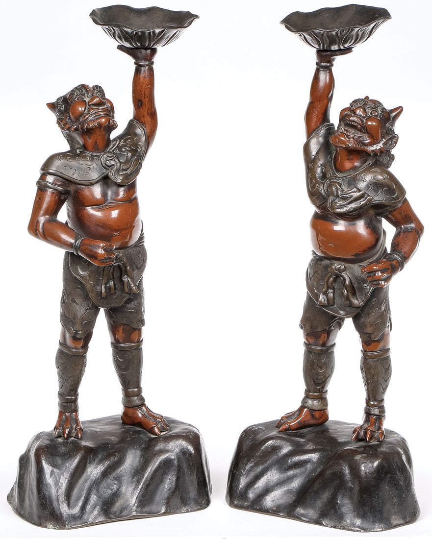 PAIR OF BRONZE JAPANESE ONI, MEIJI: PAIR OF BRONZE JAPANESE ONI, MEIJI. Comprising a pair of finely sculpted patinated bronze standing Oni figures, each depicted atop a boulder and holding a plant-form bowl in outstretched arms. Height 