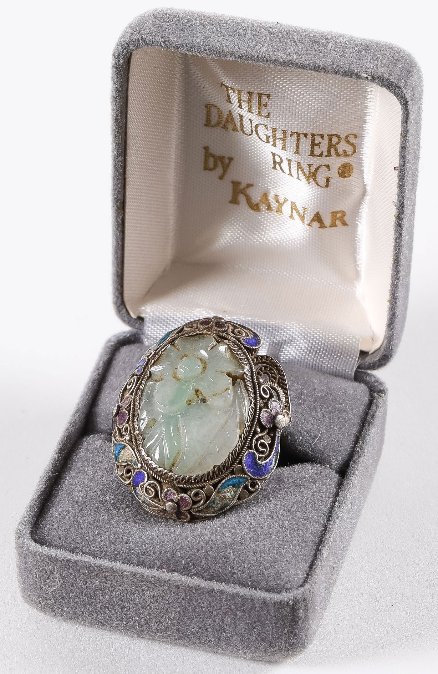CHINESE SILVER JADE & ENAMEL RING: CHINESE SILVER JADE & ENAMEL RING. Comprising a large Chinese silver filigree and cloisonne enameled ring mounted with a pierced carved jade oval floral medallion. SHIPPING NOTICE: If you are not usin