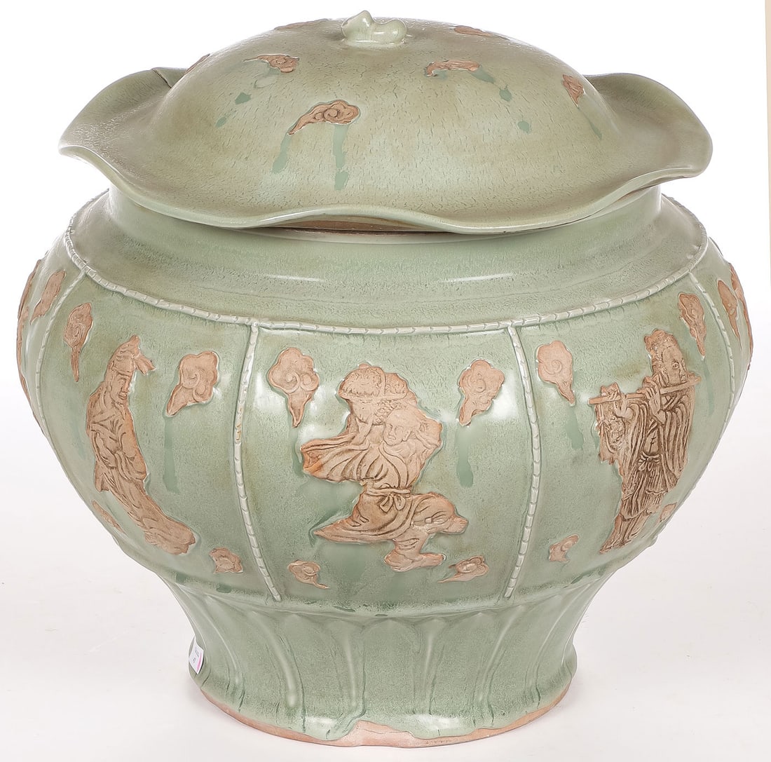 CHINESE LONGQUAN WARE COVERED JAR: CHINESE LONGQUAN WARE COVERED JAR. The sides with applied 8 immortals' decoration and with lotus leaf form fitted cover. Height 13.5 inches (34.3cm), diameter 13.25 inches (33.7cm). SHIPPING NOTICE: I