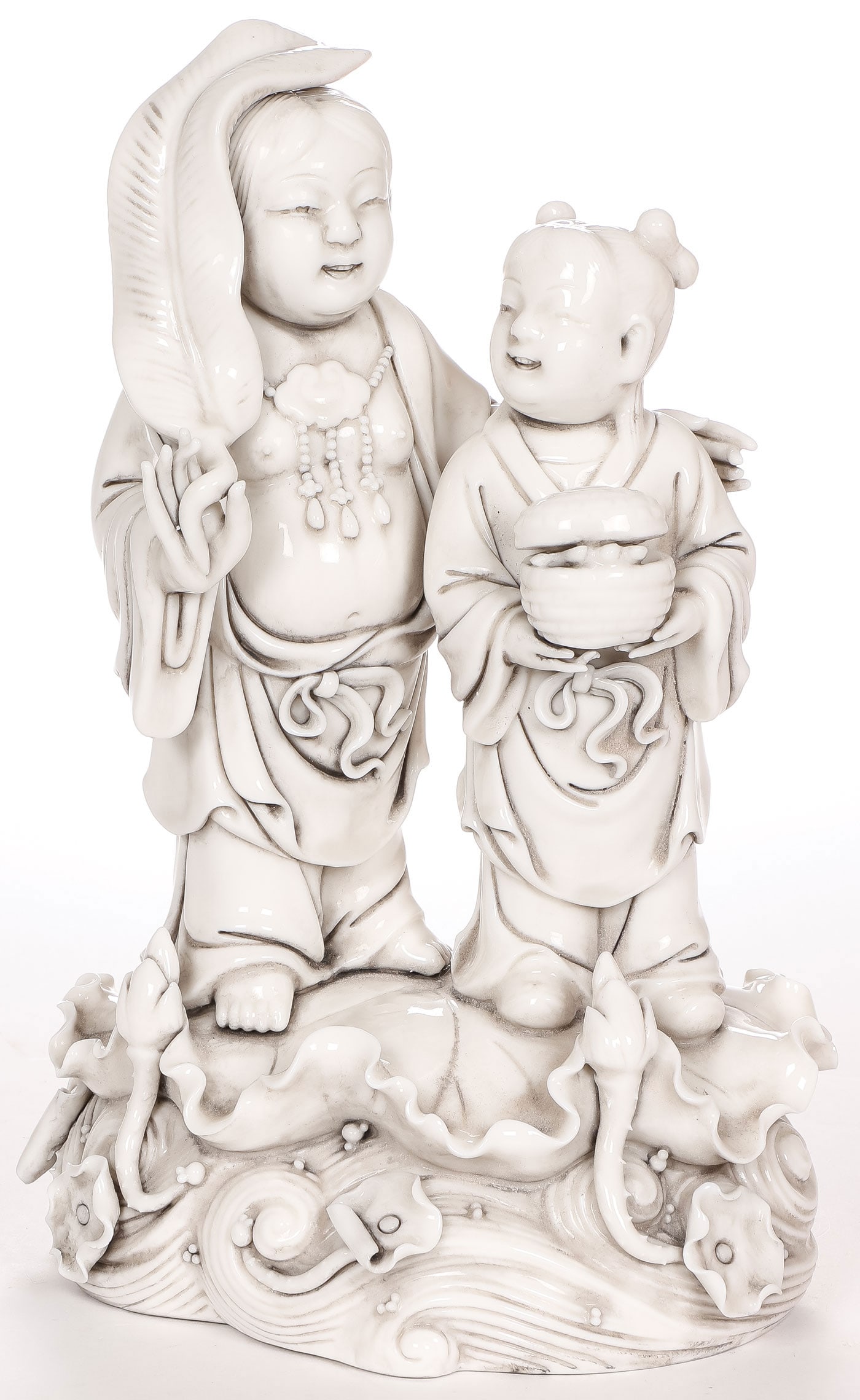 CHINESE DEHUA WARE FIGURAL GROUP: CHINESE DEHUA WARE FIGURAL GROUP. Finely sculpted in full round, the two figures resting on a lotus leaf atop of water, with custom fitted case, height 11 inches (27.9cm). The case measuring 13.5 x 19