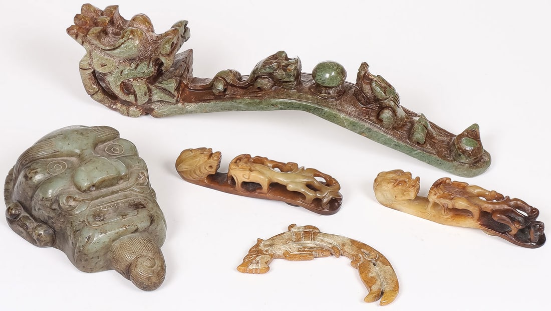 CHINESE ARCHAIC STYLE CARVED HARDSTONE: CHINESE ARCHAIC STYLE CARVED HARDSTONE. Comprising five individual pieces, including a carved dragon-form ruyi scepter, two dragon-form belt hooks, a heavy carved jade mask, and an archaic-style carve