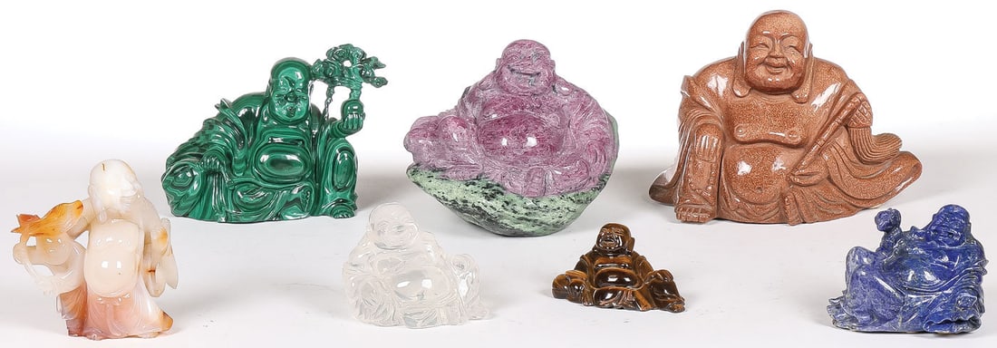 CHINESE CARVED HARDSTONE BUDDHAS: CHINESE CARVED HARDSTONE BUDDHAS. Comprising seven individually carved Buddhas as shown. Rendered in a variety of materials, including a large ruby in zoisite laughing Buddha, a large gold stone laugh