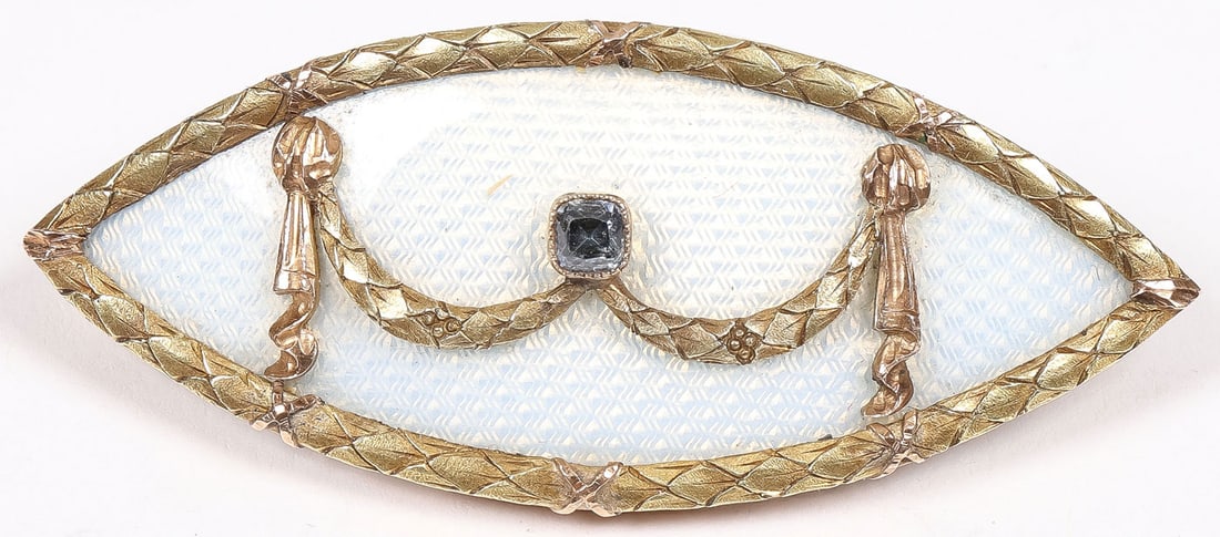 A FABERGE GOLD, GEM SET & ENAMEL BROOCH: A FABERGE GOLD, GEM SET & ENAMEL BROOCH. The double pointed oval banded in ribbon tied gold chased laurels and the center in translucent white enamel over a guilloche ground, upon which is set varicol