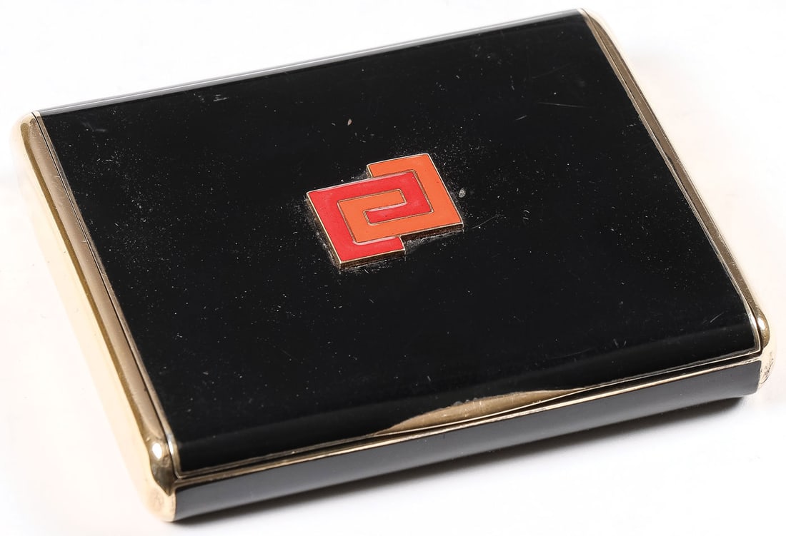 FRENCH ART DECO GOLD & SILVER CASE: FRENCH ART DECO GOLD & SILVER CASE. Of rectangular form with rounded corners, the hinged lid and base in black enamel, and the lid set with red and orange interlocked monogram. The interior stamped