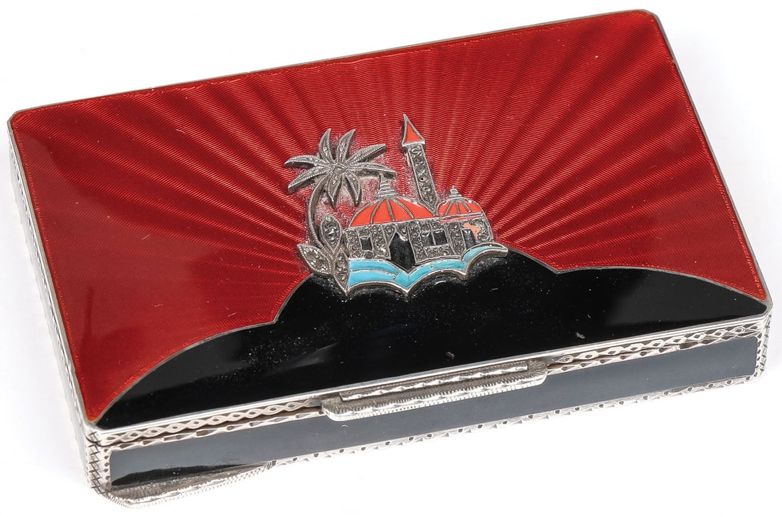 GREAT ART DECO SILVER & ENAMEL CASE: GREAT ART DECO SILVER & ENAMEL CASE. Of rectangular form with rounded corners, the hinged lid in translucent red enamel over a guilloche sunburst ground, set with a desert palace with domed roofs and 