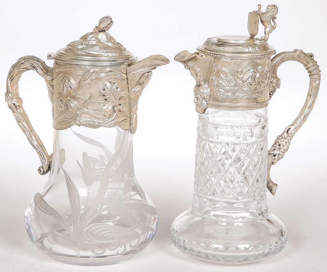 PAIR OFVERY FINE SILVER MOUNTED CLARET JUGS: PAIR OFVERY FINE SILVER MOUNTED CLARET JUGS, C. 1900. Comprising a pair of very fine silver-mounted, cut and etched glass claret jugs. Including a spectacular Art Nouveau-style example, the glass body