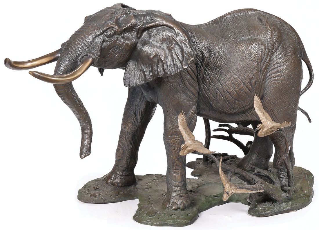 ARTIST SIGNED BRONZE ELEPHANT SCULPTURE: William Davis (American 1949-2010) Bull Elephant with Cattle Egrets -1998 Bronze with greenish brown patina Signed on base, AP/25, and dated 1998 Height 17.75 inches (45.1cm), length 29 inches