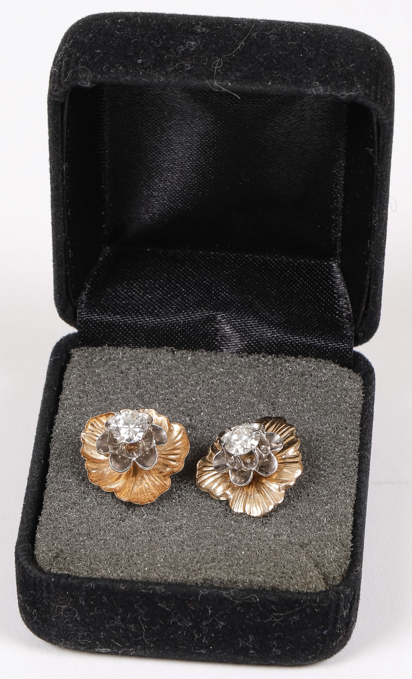 PAIR OF GOLD & DIAMOND EARRINGS: PAIR OF GOLD & DIAMOND EARRINGS. Comprising a very attractive pair of 14K gold and diamond earrings. Each earring centered with an approximate 3/4 carat brilliant-cut diamond set in a white gold six-l