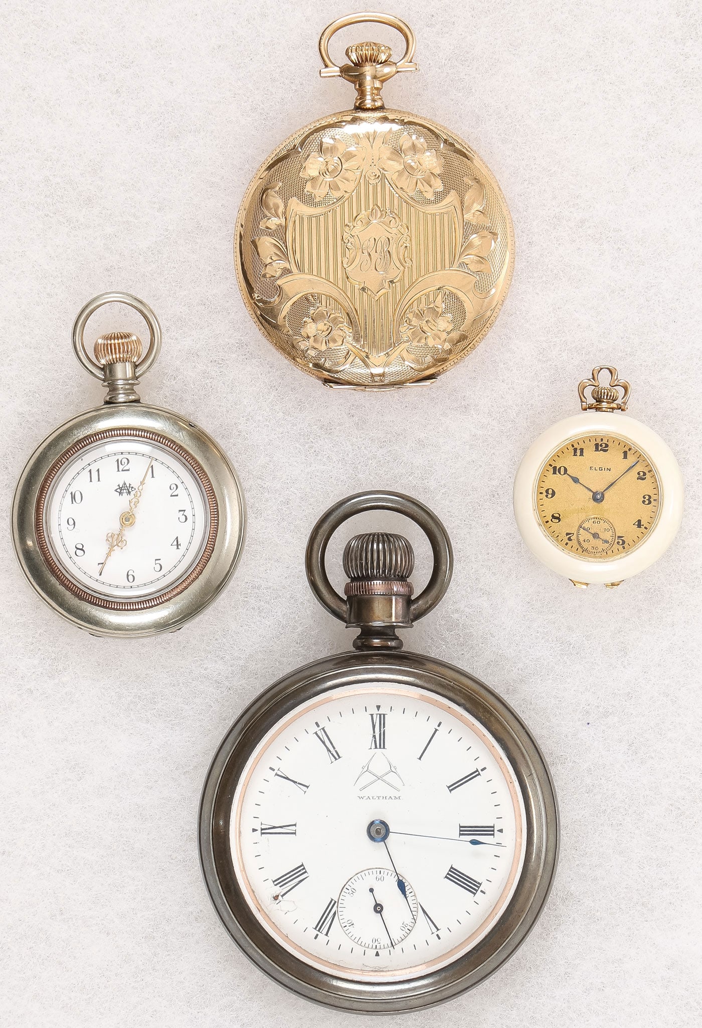 GOLD AND SILVER POCKET WATCHES: GOLD AND SILVER POCKET WATCHES. Comprising four individual watches, including an Elgin 14K gold pocket watch, engraved hunt-case, grade 314, model 2, movement serial number 21045407, 15 jewels, enamel