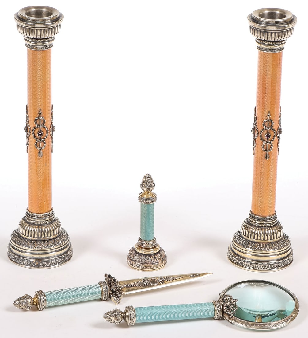 PAIR OF FABERGE STYLE SILVER & ENAMEL ITEMS: PAIR OF FABERGE STYLE SILVER & ENAMEL ITEMS. Comprising a pair of silver-gilt and enamel candlesticks. The central column in translucent salmon-coloured enamel over a wavy guilloche ground, bearing St